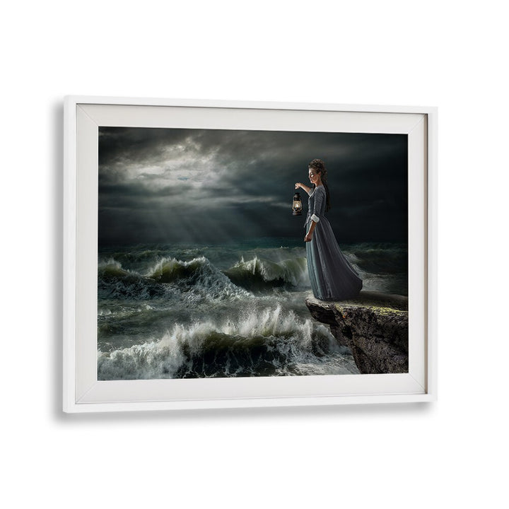 A woman in a dark gown stands by crashing waves, showcasing STORM MAID, PHOTOGRAPHY PRINTS for a dreamy escape.