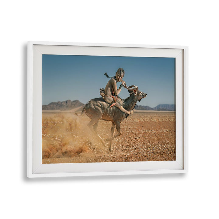 EASY RIDER, PHOTOGRAPHY PRINTS showcase a child riding a graceful animal in a stunning desert landscape.