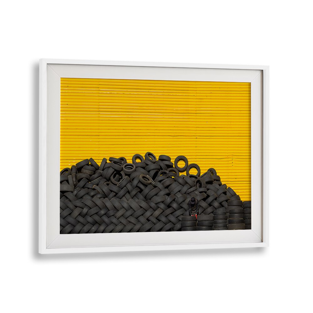 Stacked black tires against a vibrant yellow background, perfect for showcasing TIRES, PHOTOGRAPHY PRINTS art.
