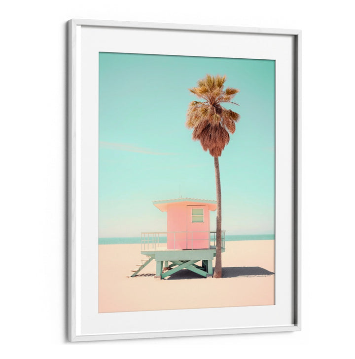 BEACHSIDE PINK BLISS, BEACH PAINTINGS showcase a vibrant lifeguard tower framed by a palm tree on a sunlit beach.