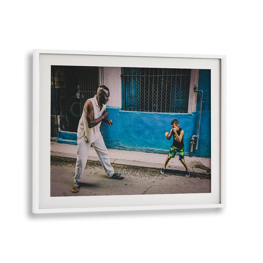 Dynamic street scene featuring a man and child practicing boxing, highlighting NEXT CHAMP, PHOTOGRAPHY PRINTS.