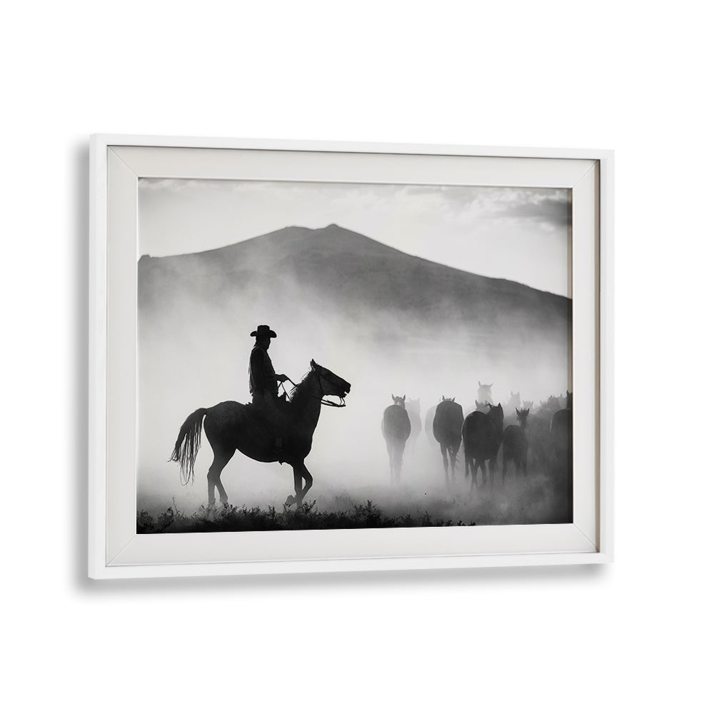 A cowboy on horseback leads a herd through fog, showcasing "HIS TERRITORY! , PHOTOGRAPHY PRINTS" in stunning detail.