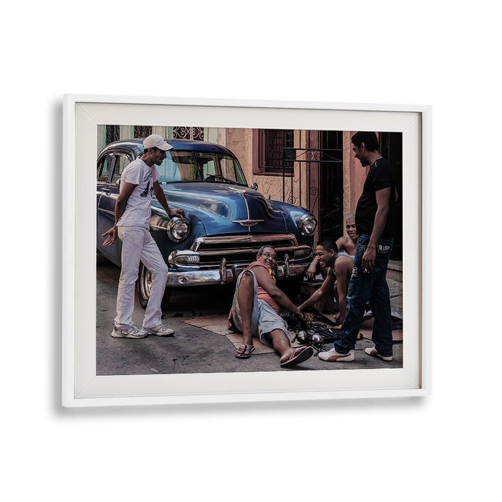 Urban scene showcasing four men repairing a car, ideal for REPAIRING A CAR, PHOTOGRAPHY PRINTS collection.