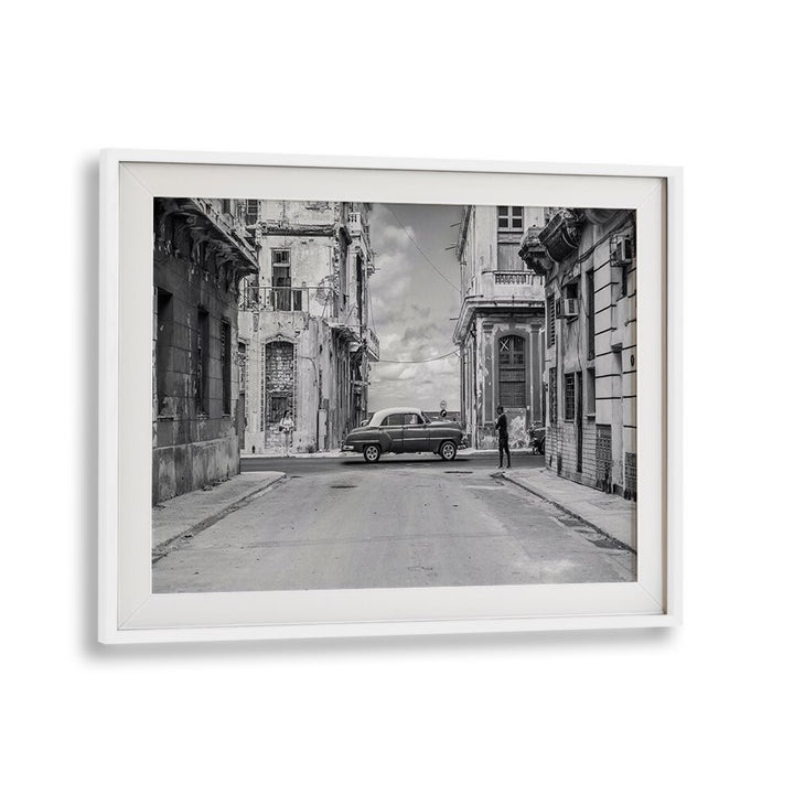 Streets of L'Avana, Photography Prints showcase a classic car on a vibrant Havana street scene, capturing urban life.