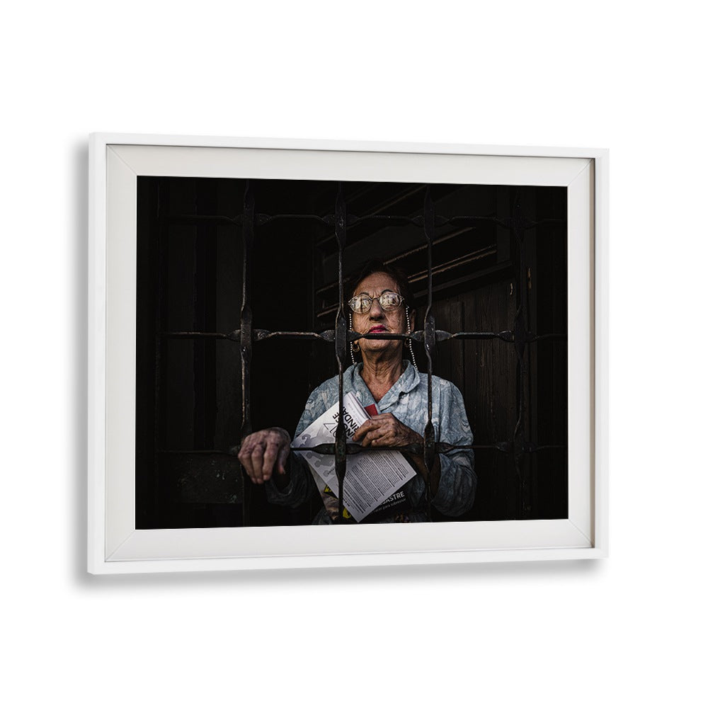 Portrait of a woman behind bars, conveying resilience in the "WOMAN FROM MATANZAS, PHOTOGRAPHY PRINTS" collection.