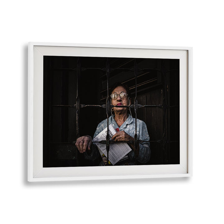 Portrait of a woman behind bars, conveying resilience in the "WOMAN FROM MATANZAS, PHOTOGRAPHY PRINTS" collection.