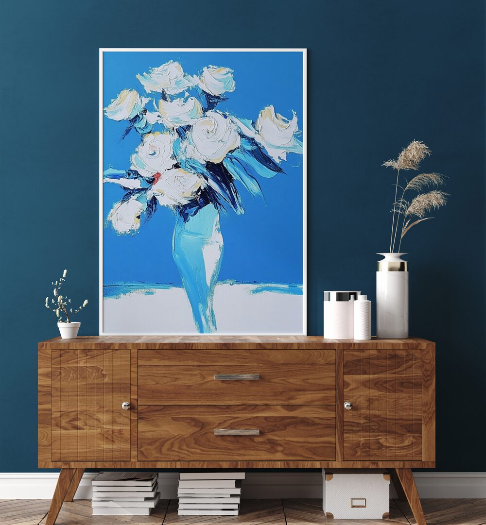Elegant white roses in a blue vase, perfect for enhancing home decor. Discover the beauty of WHITE ROSES IN A BLUE VASE.
