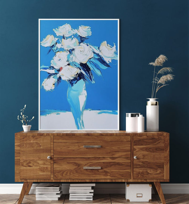 Elegant white roses in a blue vase, perfect for enhancing home decor. Discover the beauty of WHITE ROSES IN A BLUE VASE.