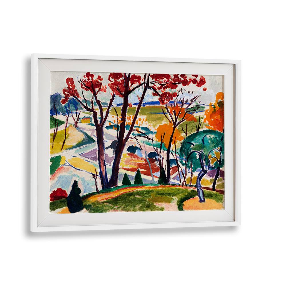 This framed artwork, titled "LANDSCAPE, BRIDGE, HUNTINGDON VALLEY (CA.1915 - 1916)," from the Asianmonk brand's Masters Art collection, captures a vibrant landscape scene with red and orange trees alongside a blue tree, rolling hills, and a winding road. The piece is characterized by bold colors and abstract elements reminiscent of Henry Lyman Saÿen paintings and is beautifully accented with a simple white frame.