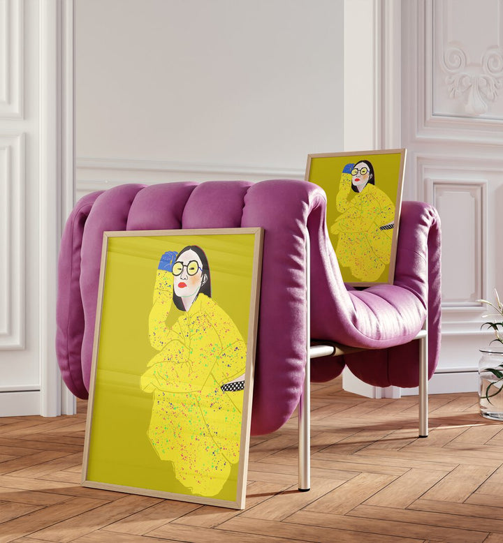 Wait I Am Resting By Ana Sneeringer Wall Art Paintings in Oak Wood Plain Frame placed on a floor beside a pink sofa and on the sofa