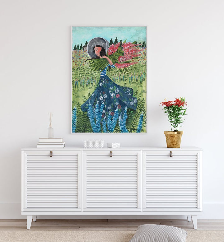 Walking With Field Flowers By Caroline Bonne Muller Women Paintings in White Plain Frame on a white wall above a console table