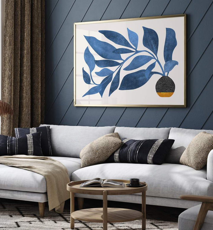 Wandering Ivy in Blue by Kristian Gallagher Botanical Flower Paintings Floral Paintings in Golden Plain Frame placed on a wall behind a white sofa for living room