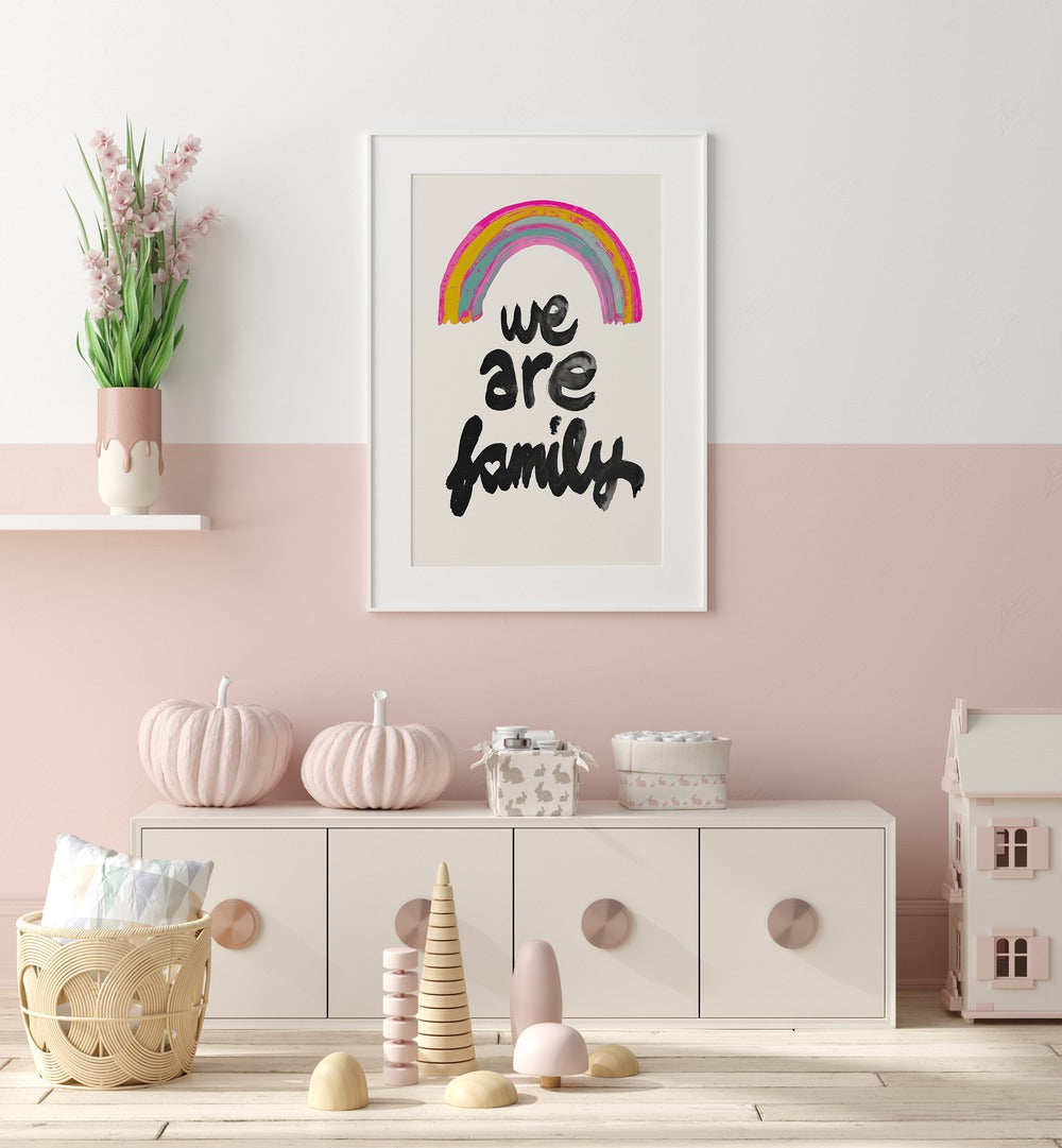 We Are Family By Treechild Kids Room Paintings in White Frame With Mount placed on a Pink Colored Wall in the Kids Room