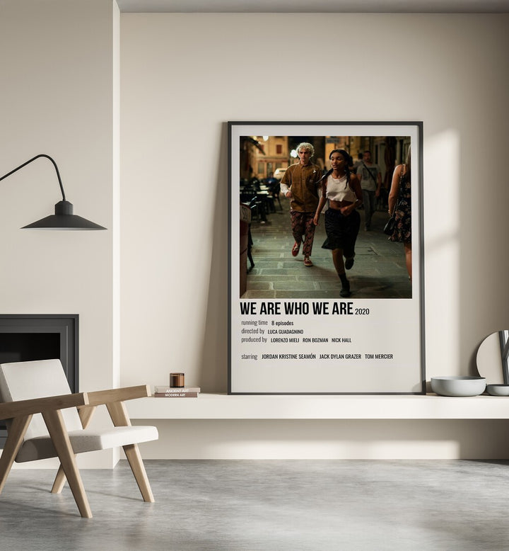 We Are Who We Are 2020 Movie Posters in Black Plain Frame placed on a shelf beside a hearth