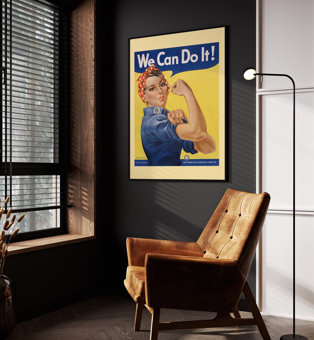 We Can Do It  Women Illustrations paintings in Black Plain Frame on a wall beside an orange sofa