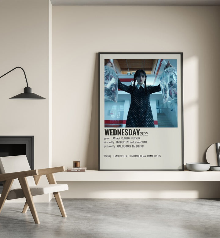 Wednesday 2022 Movie Posters in Black Plain Frame placed on a shelf beside a hearth