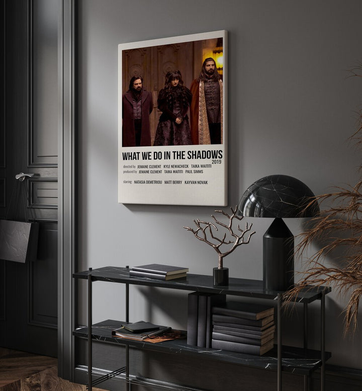 What We Do In The Shadows 2019 Movie Posters in Gallery Wrap placed on a wall behind a black table and beside a door