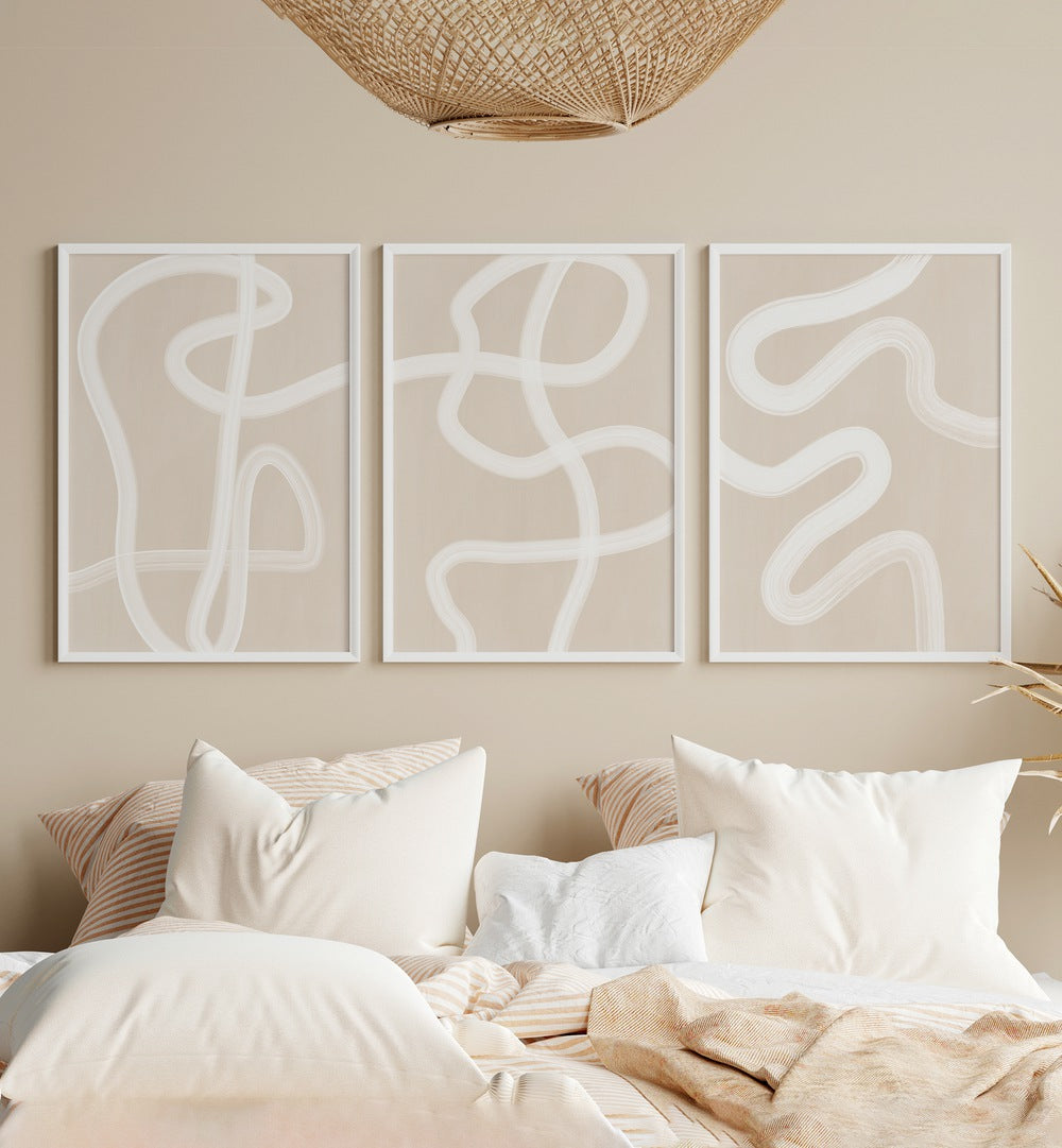 White Brush Strokes Set Of 3 Paintings in White Plain Frame placed on a bedroom wall behind a bed