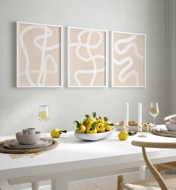 White Brush Strokes Set Of 3 Paintings in White Plain Frame placed on a wall behind a dining table for dining area