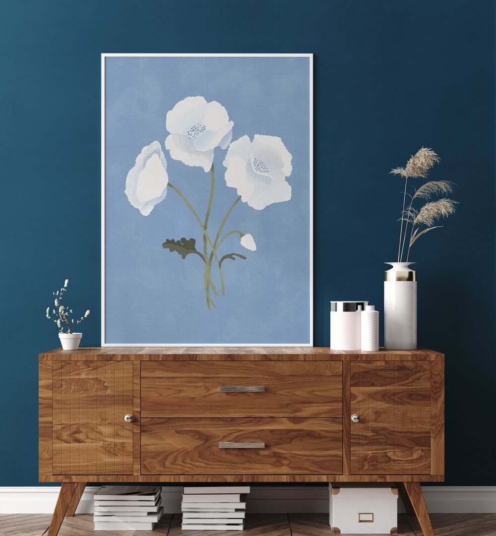 White On Blue By Goed Blauw Botanical Art Prints in White Plain Frame placed on a Console Table near a Blue Colored Wall in the Drawing Room