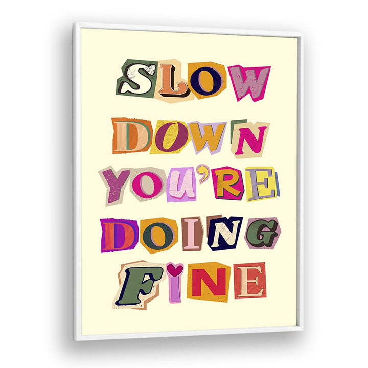 Colorful framed wall art featuring the phrase "SLOW DOWN YOU'RE DOING FINE," perfect for any inspirational decor.