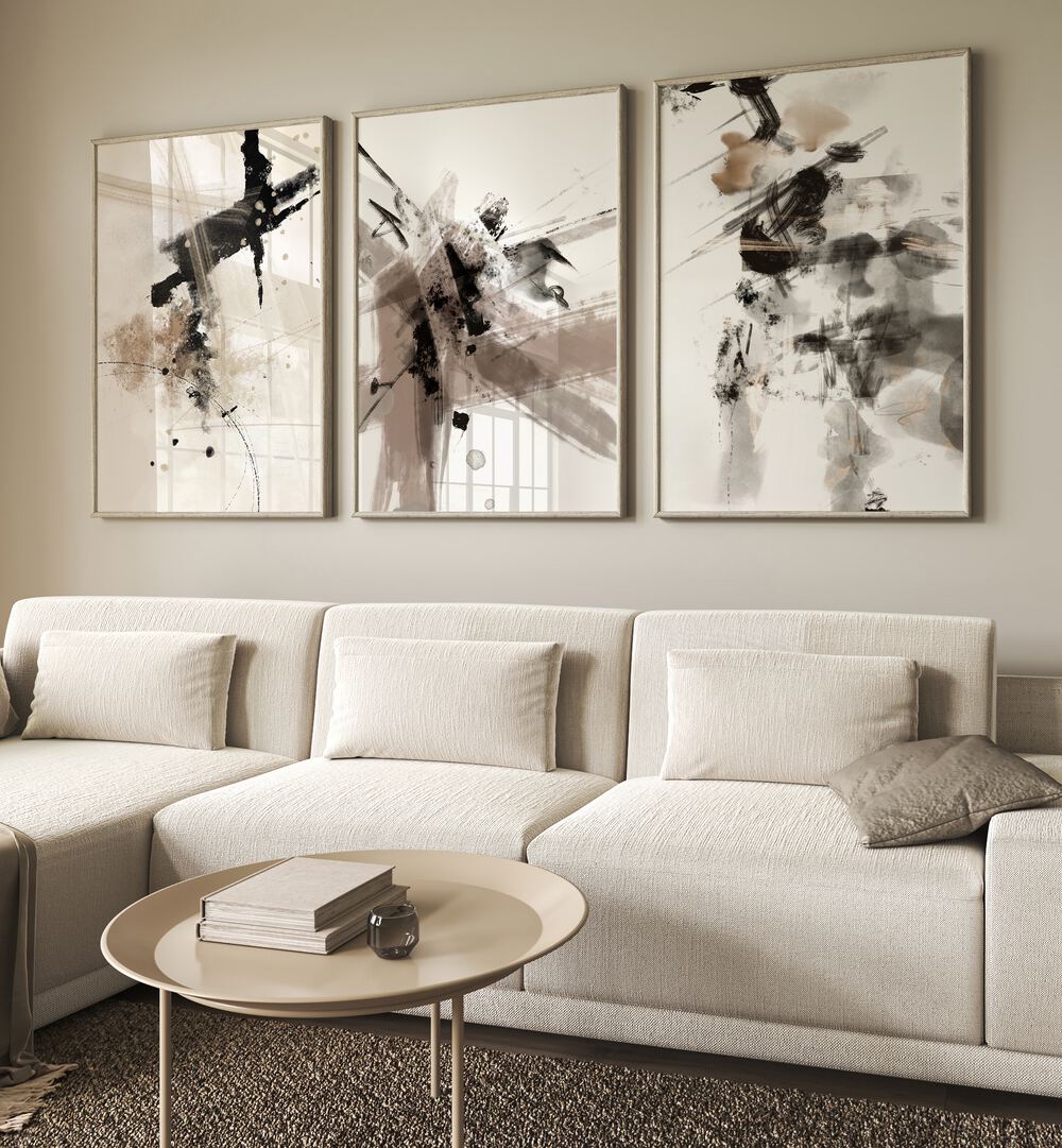 Wild Words Set Set Of 3 Paintings in White Plain Frame placed on a living room wall behind a white sofa