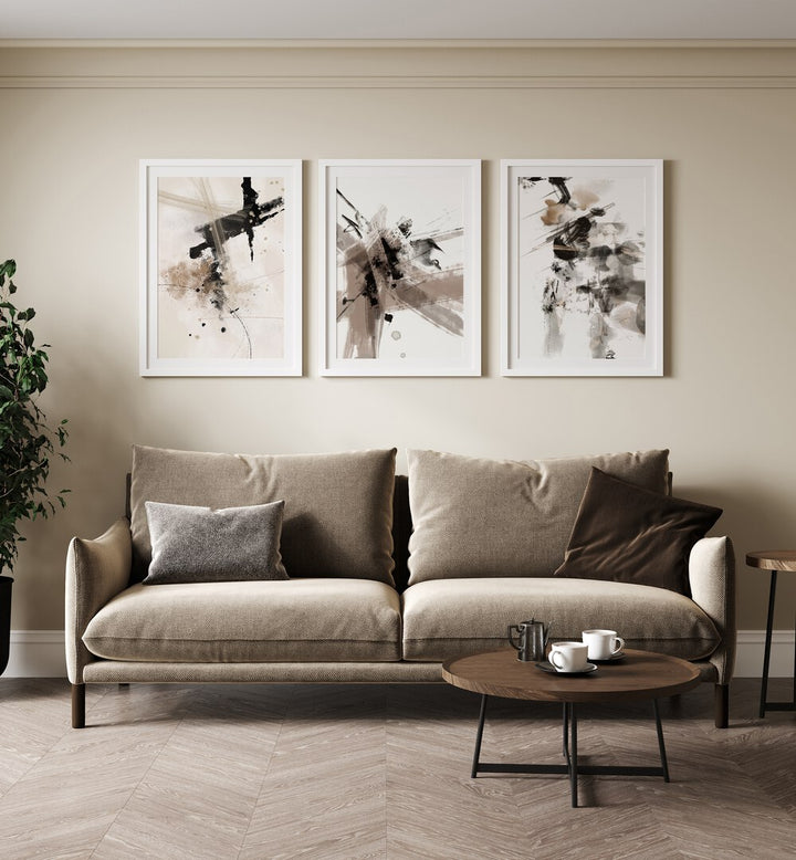 Wild Words Set Set Of 3 Paintings in White Frame With Mount placed on a beige wall behind  a brown sofa for living room