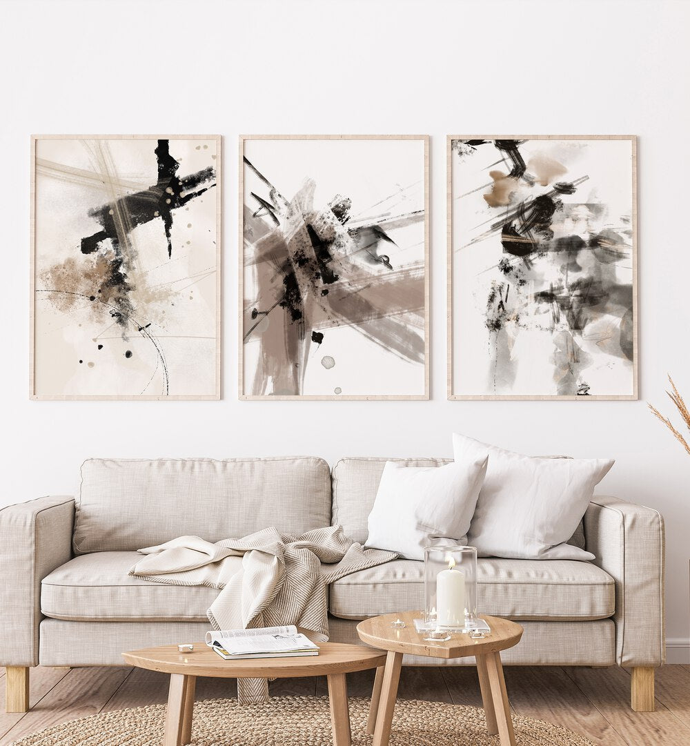 Wild Words Set Set Of 3 Paintings in Oak Wood Plain Frame placed on a white wall behind a sofa