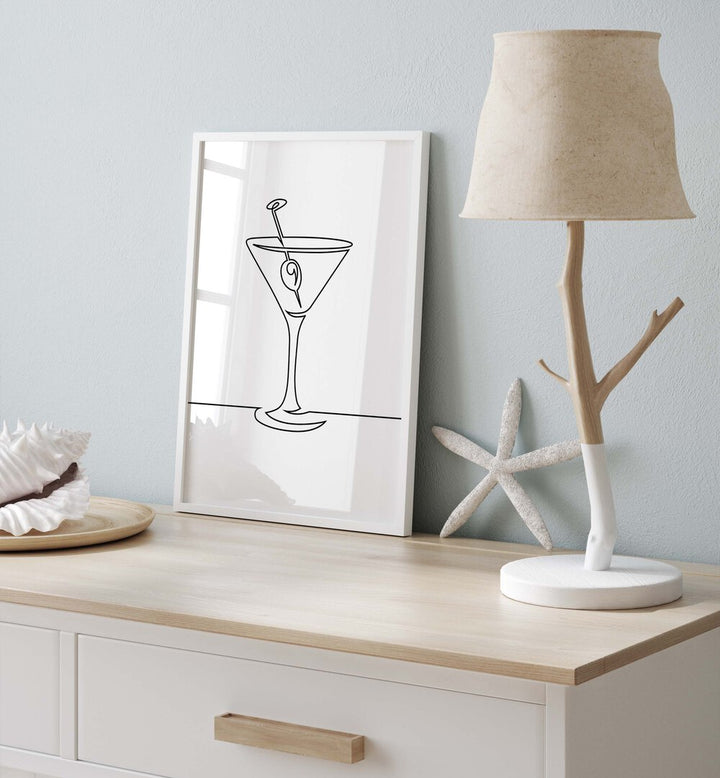 Wine Glass Cafe Art Prints Cafe Posters in White Plain Frame placed on a console table beside a lamp and seashells