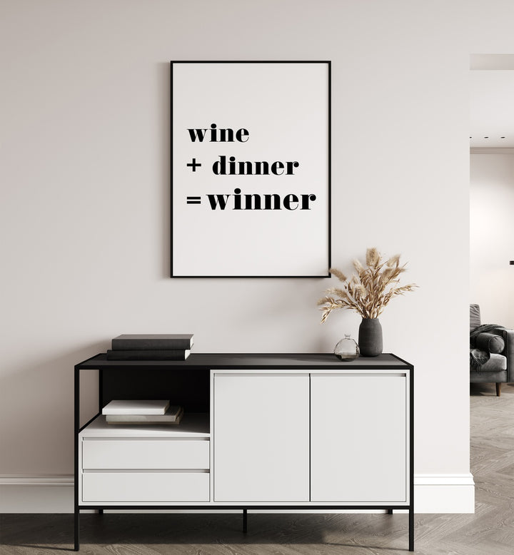 Winner By 1 X Studio Quotes And Typography Posters in Black Plain Frame placed on a White Colored Wall above a Console Table in the Drawing Room