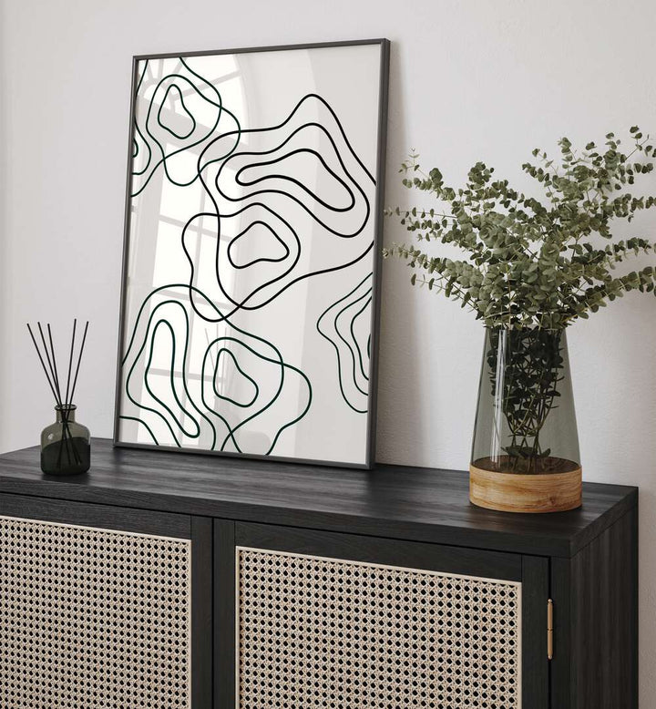 Wobbly Woo By Grishma Korjani Line Art Prints in Black Plain Frame placed on a Console Table