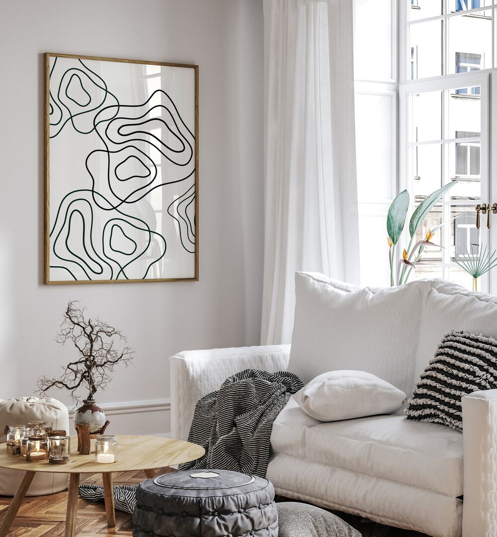 Wobbly Woo By Grishma Korjani Line Art Prints in Oak Wood Plain Frame placed on a White Colored Wall near a White Sofa  in the Living Room