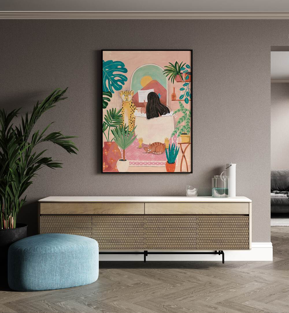 Woman Taking Bath In Pink Tropical Bathroom By Caroline Bonne Muller Women Illustration Paintings in Black Plain Frame on a wall above a console table beside a plant