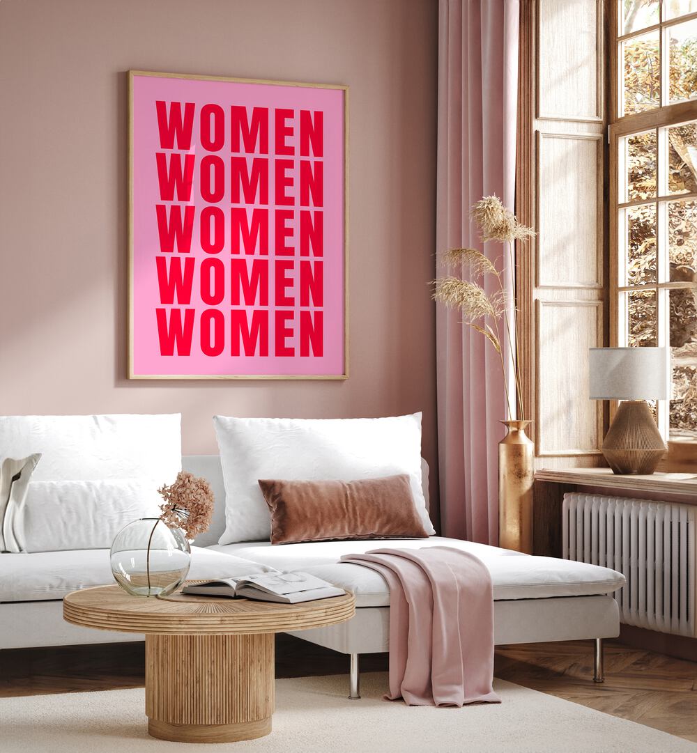 Women women by Athene Fritsch Quotes and Typography Posters in Oak Wood Floater Frame placed on a living room wall behind a sofa and beside a window