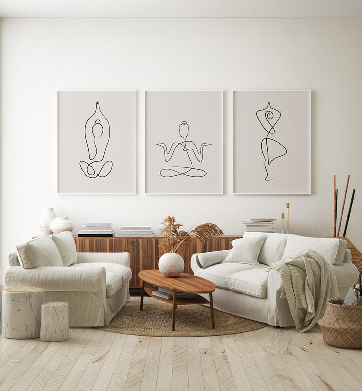 Yoga Line Art Set Set Of 3 Paintings in White Plain Frame placed on a white wall behind a console table for living room