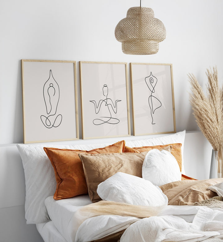 Yoga Line Art Set Set Of 3 Paintings in Oak Wood Plain Frame placed on the shelf behind a bed for bedroom