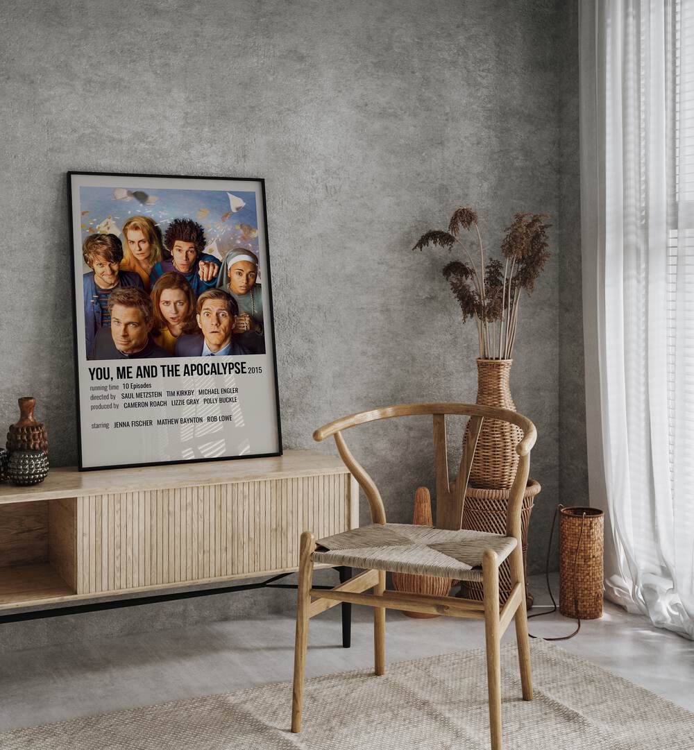 You Me and the Apocalypse 2015 Movie Posters in Black Plain Frame placed on a console table behind a chair