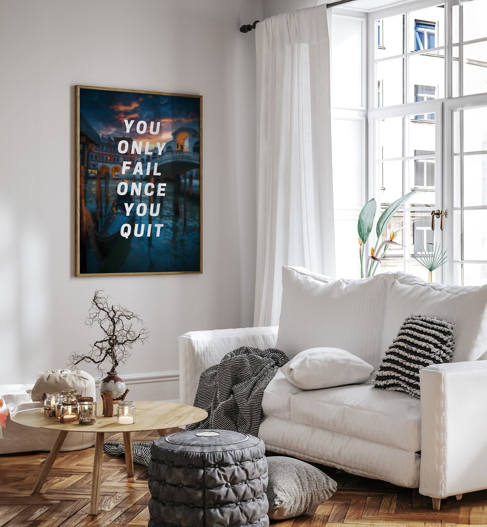 You Only Fail Once You Quit Quotes And Typography Posters in Oak Wood Plain Frame placed on a White Colored Wall near a White Sofa in the Living Room