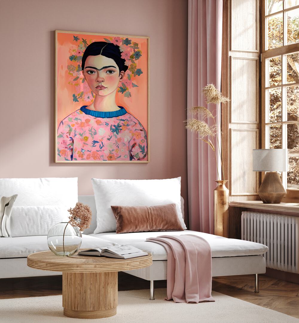 Young Frida Peach By Treechild Women Illustration Art Prints in Oak Wood Plain Frame placed on a Pink Colored Wall near a White Sofa in the Living Room