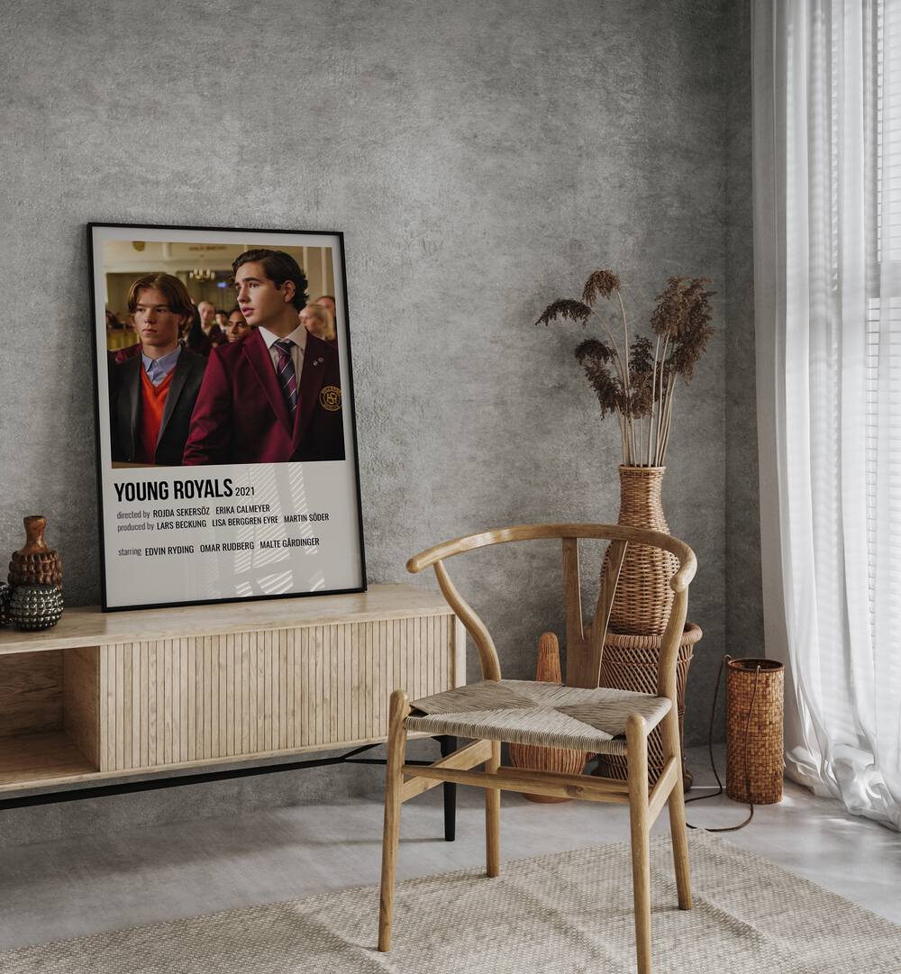 Young Royals 2021 Movie Posters in Black Plain Frame placed on a console table behind a chair