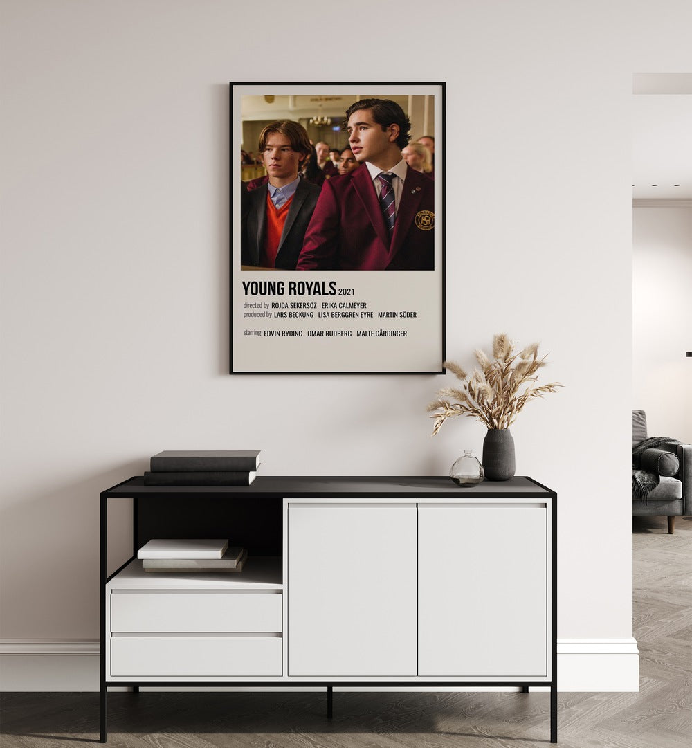 Young Royals 2021 Movie Posters in Black Plain Frame placed on a wall behind a white and black table 