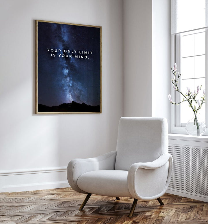 Your Only Limit Is Your Mind Quotes And Typography Posters in Oak Wood Plain Frame placed on a White Colored Wall near a White Sofa Chair in the Drawing Room