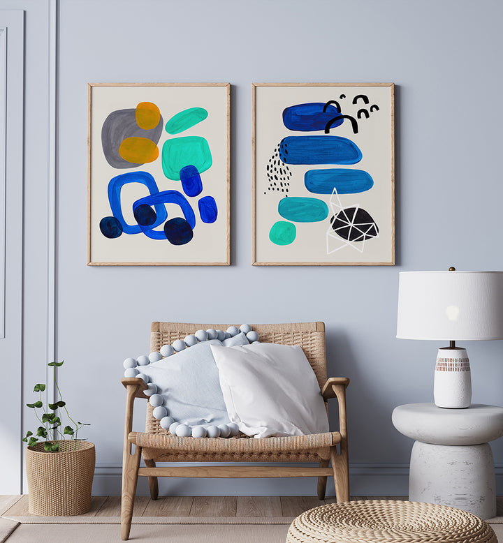 Living room with abstract art on the wall, a wicker chair, and a lamp.