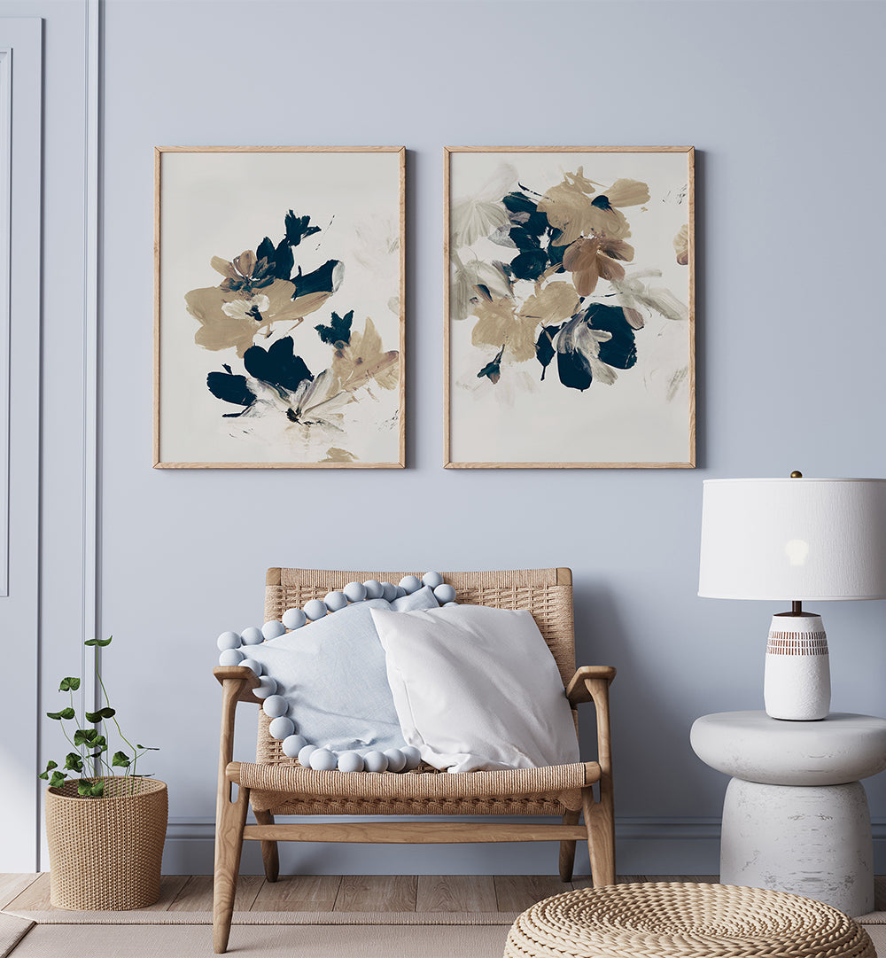 Living room with wicker chair, floral artwork, and lamp against a light blue wall.