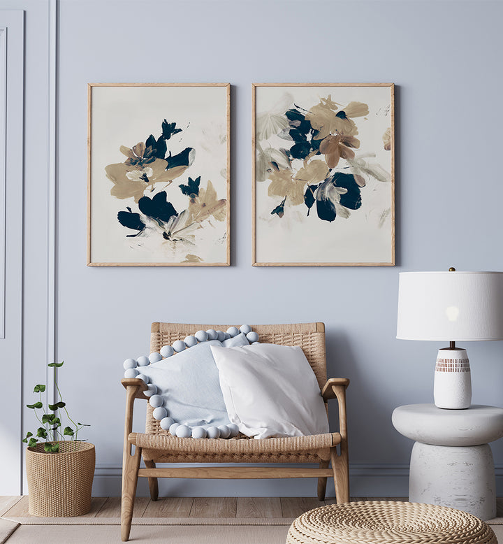 Living room with wicker chair, floral artwork, and lamp against a light blue wall.